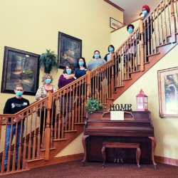Heritage Woods staff lines up on the stairs near the front entrance